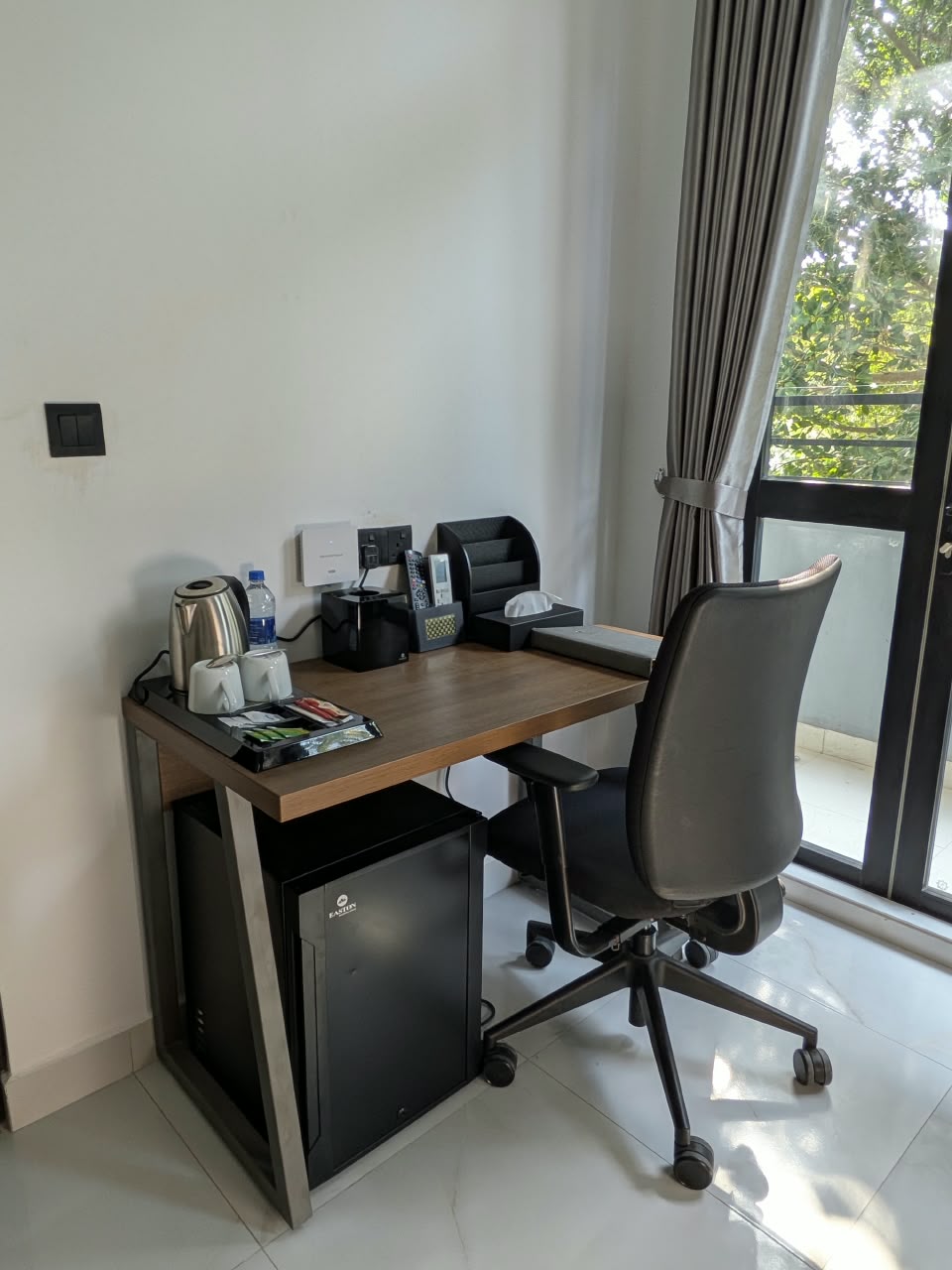 Workspace beside the window with mini-fridge